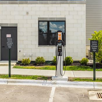 An electric vehicle charging station sits outside a building